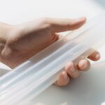 Hand bending clear silicone tube to show elasticity